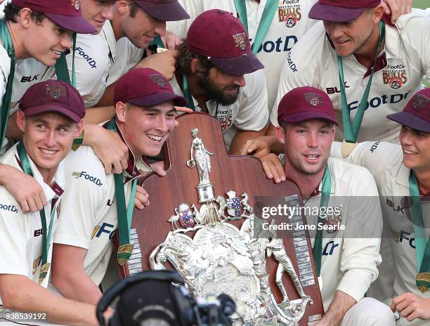 The Queensland team celebrates winning the match during day five of the Sheffield Shield final match between Queensland and Tasmania at Allan Border...