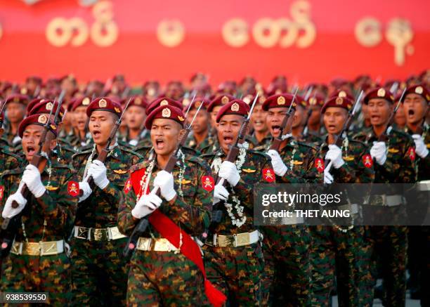 Myanmar soldiers march in formation during a military parade in Naypyidaw on March 27, 2018 to mark the 73rd Armed Forces Day. / AFP PHOTO / Thet AUNG