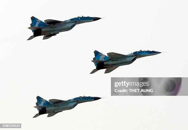 Russian MIG-29 fighter jets of the Myanmar Air Force fly in formation during a military parade in Naypyidaw on March 27, 2018 to mark the 73rd Armed...