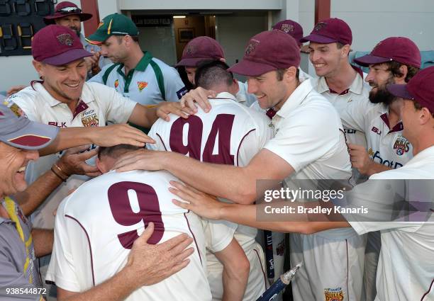 Queensland players celebrate victory during day five of the Sheffield Shield final match between Queensland and Tasmania at Allan Border Field on...