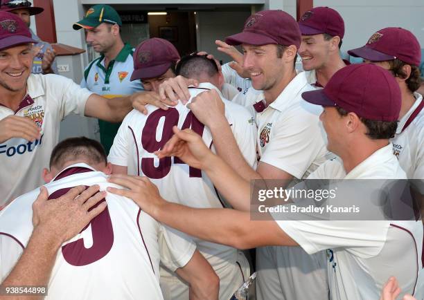 Queensland players celebrate victory during day five of the Sheffield Shield final match between Queensland and Tasmania at Allan Border Field on...