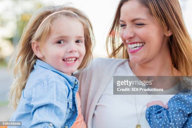 portrait of beautiful mom and daughter - november 2 2017 stock pictures, royalty-free photos & images