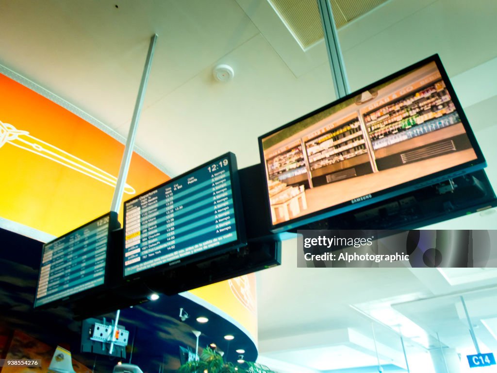 Cancun airport departure boards signs.
