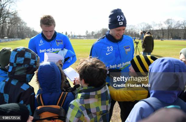 Per Skjelbred and Mitchell Weiser of Hertha BSC sign autographs for young fans after training at Schenkendorfplatz on march 27, 2018 in Berlin,...