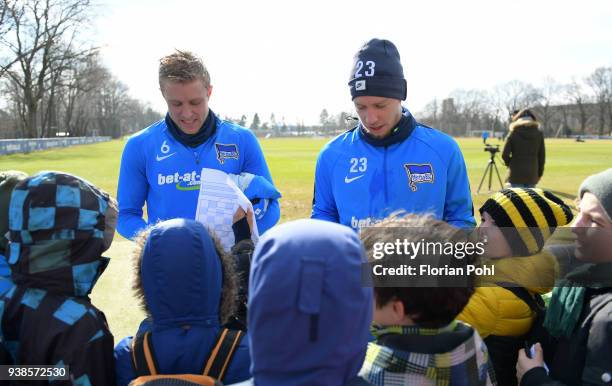 Per Skjelbred and Mitchell Weiser of Hertha BSC sign autographs for young fans after training at Schenkendorfplatz on march 27, 2018 in Berlin,...