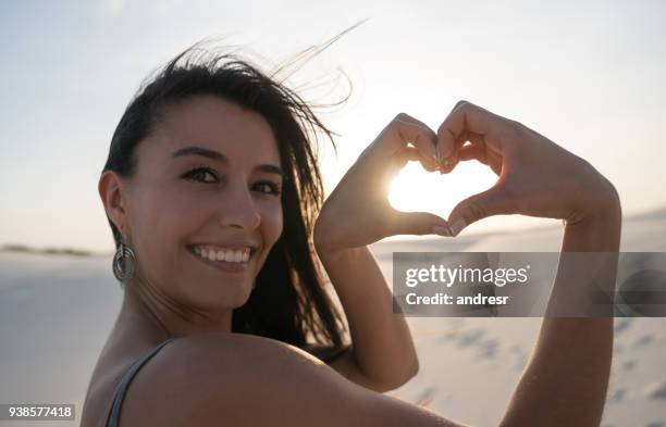 loving woman at the desert making a heart shape - lencois maranhenses national park stock pictures, royalty-free photos & images