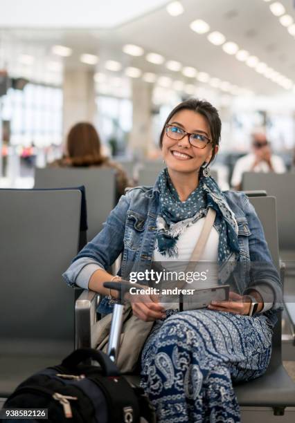 woman at the airport traveling by plane and waiting at the gate - portraits of people passport imagens e fotografias de stock