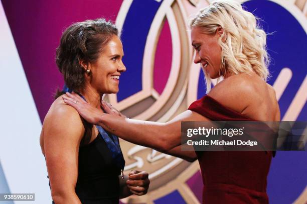 Emma Kearney of the Bulldogs receives the AFLW Medal from previous winner Erin Phillips of the Crows the 2018 AFW Awards at The Peninsula on March...