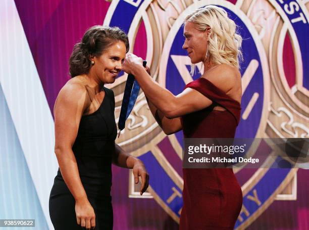 Emma Kearney of the Bulldogs receives the AFLW Medal from previous winner Erin Phillips of the Crows the 2018 AFW Awards at The Peninsula on March...