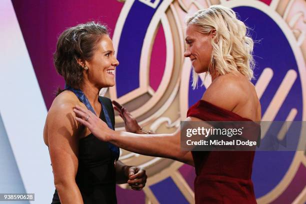 Emma Kearney of the Bulldogs receives the AFLW Medal from previous winner Erin Phillips of the Crows the 2018 AFW Awards at The Peninsula on March...