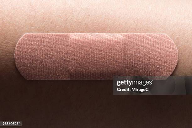 adhesive bandage on human skin - adhesive stock pictures, royalty-free photos & images