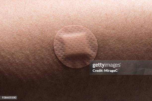 circle adhesive bandage on human skin - plåster bildbanksfoton och bilder