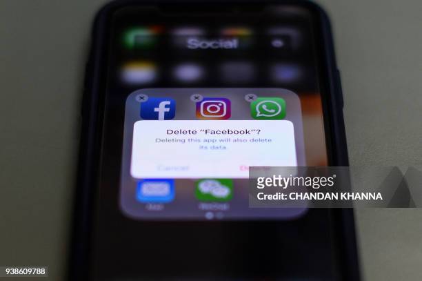 This photo illustration taken on March 27 shows apps for Facebook, Instagram, Twitter and other social networks on a smartphone in the Indian capital...