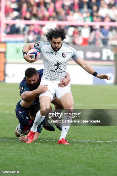 Paul Alo Emile of Stade Francais Paris tackles Yoann Huget of Stade Toulousain during the Top 14 match between Stade Francais Paris and Stade...