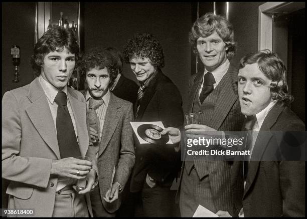 Arsenal footballers Frank Stapleton , Alan Sunderland , Willie Young and Richie Powling promoting the team's single 'Roll Out The Red Carpet',...