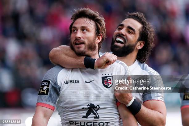 Maxime Medard celebrates with Yoann Huget of Stade Toulousain after scoring a try during the Top 14 match between Stade Francais Paris and Stade...