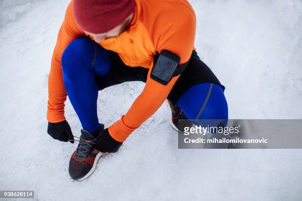 man tying sports shoes - cycling shoe stock pictures, royalty-free photos & images