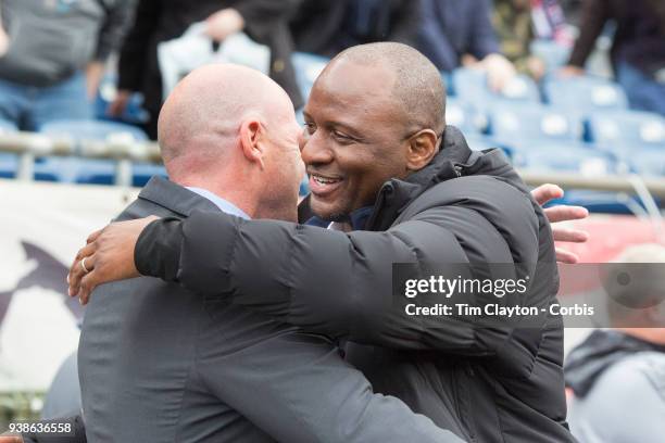 March 24: Brad Friedel, head coach of New England Revolution and Patrick Vieira, head coach of New York City FC embrace on the sideline before the...