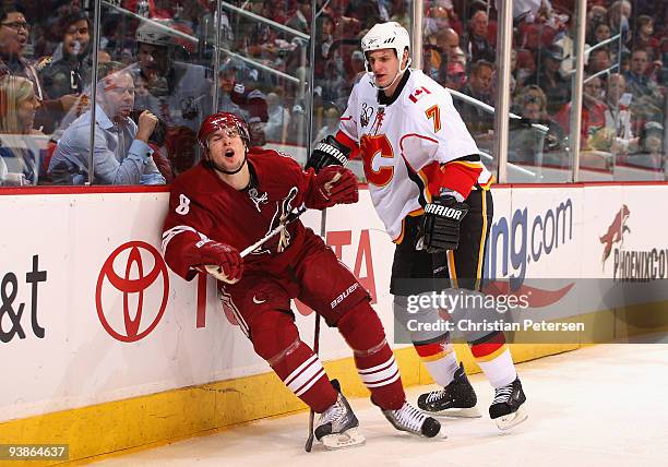 Scottie Upshall of the Phoenix Coyotes reacts after being hit by Adam Pardy of the Calgary Flames during the NHL game at Jobing.com Arena on December...