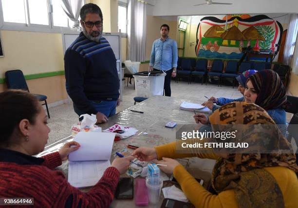 Voter casts his ballot at a polling station in the Nile Delta city of Tanta, some 100 kilometres north of the capital, on the second day of the...