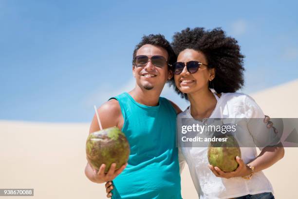 happy couple on holidays drinking at the desert - happy holidays around the world stock pictures, royalty-free photos & images