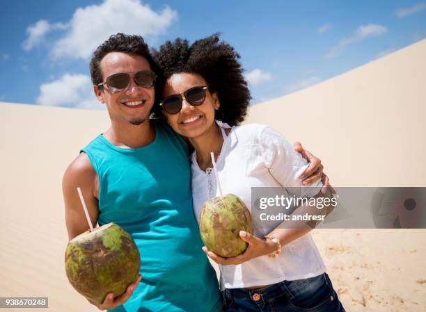 happy couple on holidays drinking at the desert - happy holidays around the world stock pictures, royalty-free photos & images