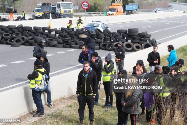 Spanish riot police clears a road blockade by Catalan separatists on AP-7 motorway linking Spain to neighbouring France, near Figueras on March 27,...