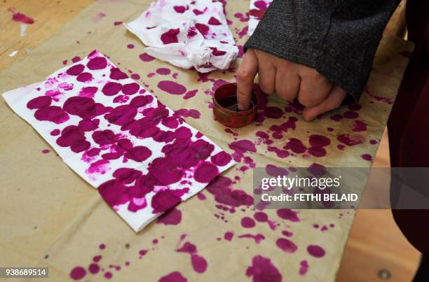 An Egyptian woman dips her pinky finger in ink after casting her vote at a polling station in the Nile Delta City of Tanta, 120 kilometres north of...