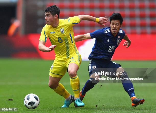 Ruslan Malinovsky of Ukraine holds off Hotaru Yamaguchi of Japan during the International Friendly match between Japan and Ukraine at Stade Maurice...