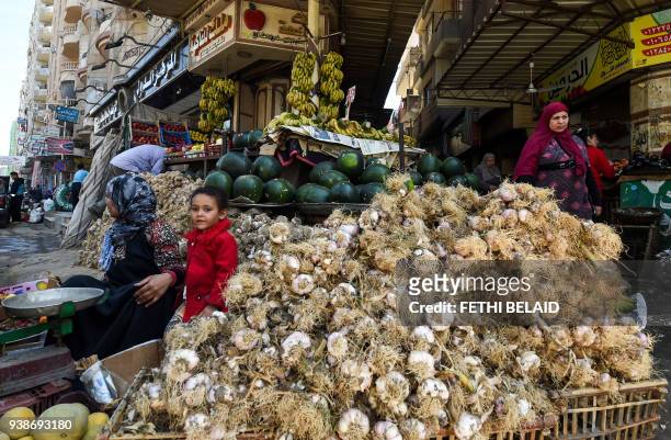 Picture taken on March 27, 2018 shows a view of an Egyptian garlic peddlar's stall at a market in the Nile Delta City of Tanta, 120 kilometres north...