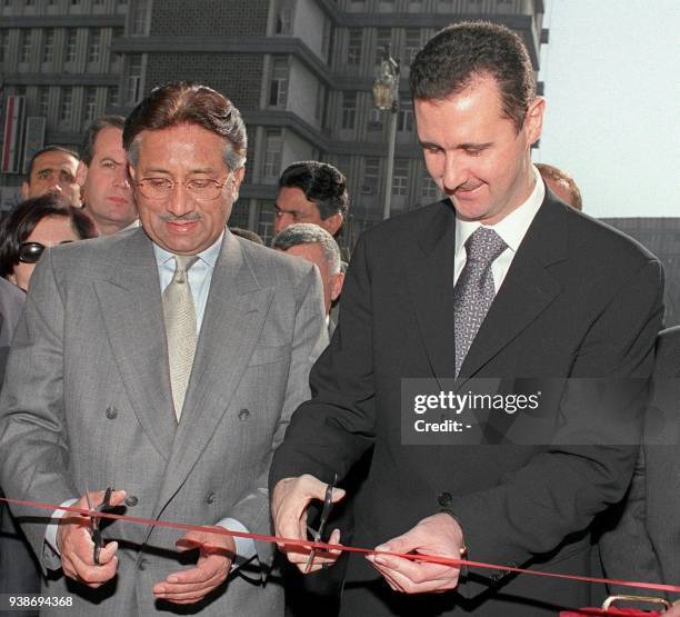 Syrian President Bashar al-Assad and Pakistani military ruler Gen. Pervez Musharraf cut the ribbon 08 January 2001 at the inauguration of the...