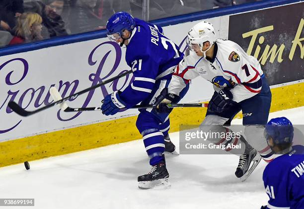 Derian Plouffe of the Toronto Marlies battles for the puck with Mark Fayne of the Springfield Thunderbirds during AHL game action on March 25, 2018...