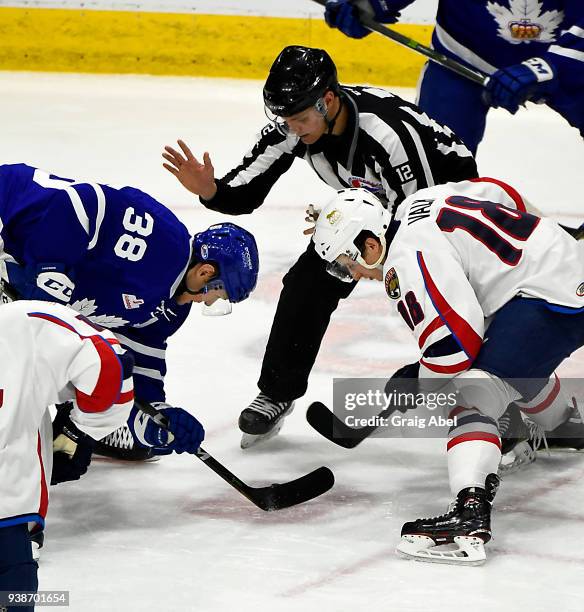 Linseman Jean Menard drops the puck between Colin Greening of the Toronto Marlies and Curtis Valk of the Springfield Thunderbirds during AHL game...