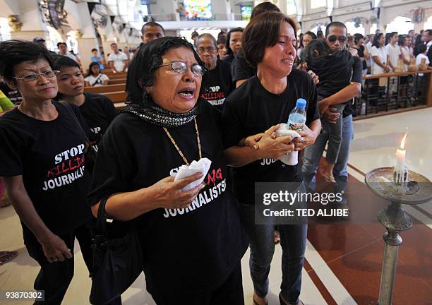 Relatives of one of the slain journalists mourn during a mass prior to the funeral in General Santos City, south Cotabato on December 4, 2009. Eight...