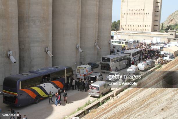 Syrian civilians are seen as a fifth convoy of vehicles carrying civilians and opposition fighters from the Damascus suburb of Eastern Ghouta arrived...