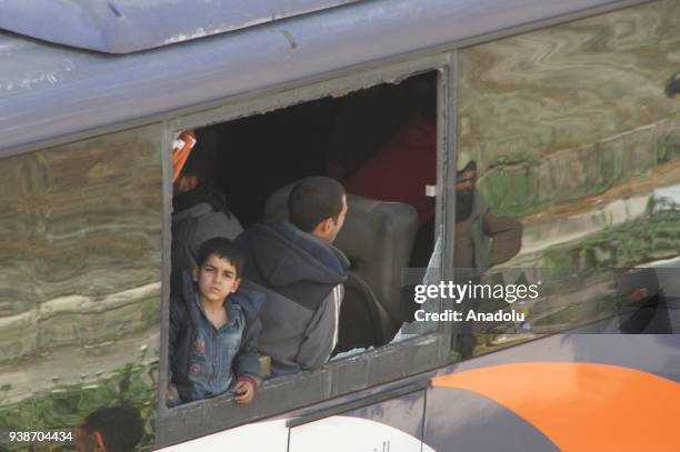 Syrian civilians are seen as a fifth convoy of vehicles carrying civilians and opposition fighters from the Damascus suburb of Eastern Ghouta arrived...