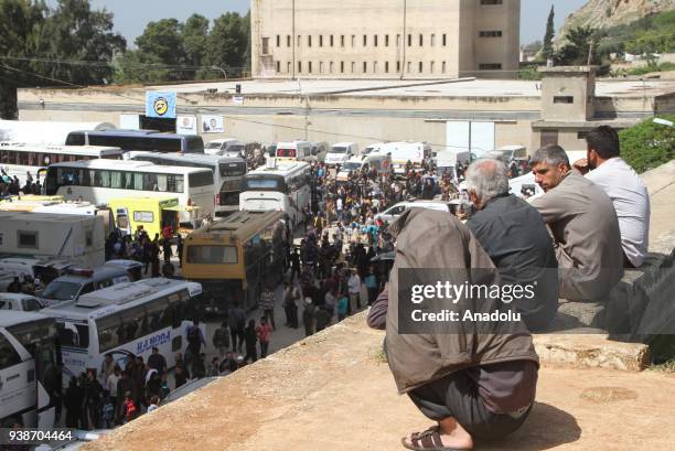 Syrian civilians are seen as a fifth convoy of vehicles carrying civilians and opposition fighters from the Damascus suburb of Eastern Ghouta arrived...