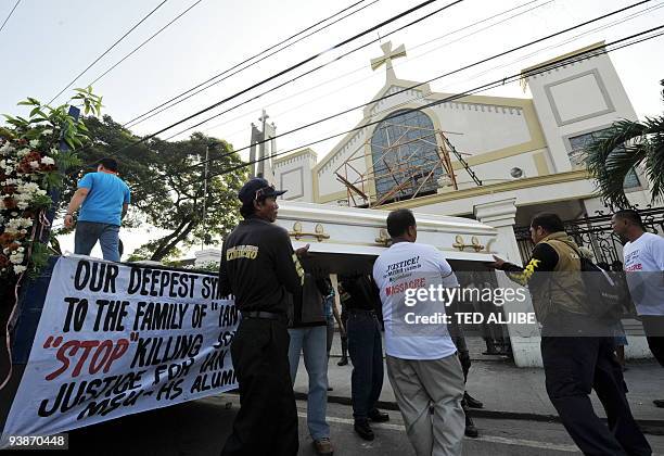 Friends of one of the slain journalists carry the coffin to the church prior to a mass in General Santos City, south Cotabato on December 4, 2009....