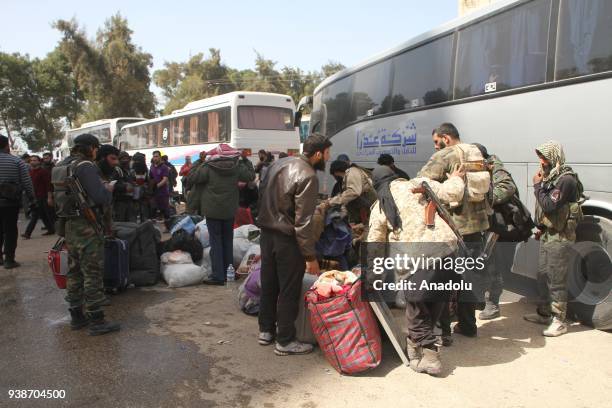 Syrian civilians are seen as a fifth convoy of vehicles carrying civilians and opposition fighters from the Damascus suburb of Eastern Ghouta arrived...