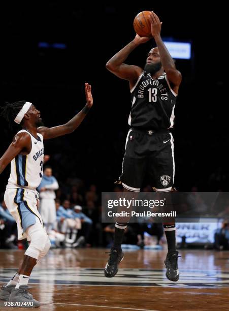 Quincy Acy of the Brooklyn Nets shoots a three point shot over Briante Weber of the Memphis Grizzlies in an NBA basketball game against the Memphis...