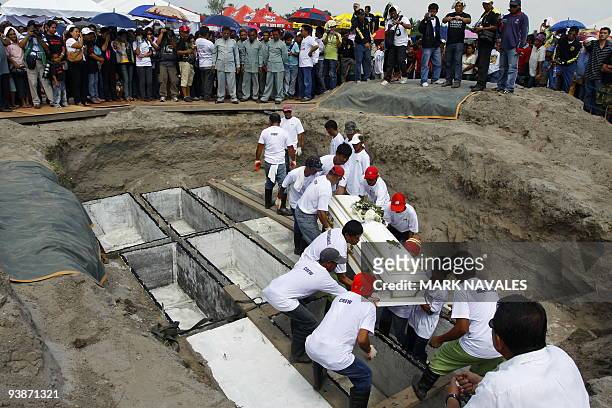 Workes carry the coffin of one of the slain journalists during the funeral in General Santos City, south Cotabato on December 4, 2009. Eight of the...