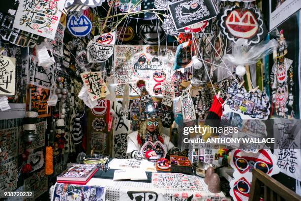 Local artist Kwok Mang Ho, also known as "Frog King", sits in his booth during the media preview of Art Basel in Hong Kong on March 27, 2018. /...