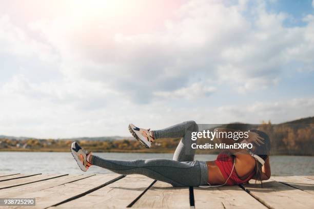 beautiful young woman getting her abs nice and trim - absinto stock pictures, royalty-free photos & images