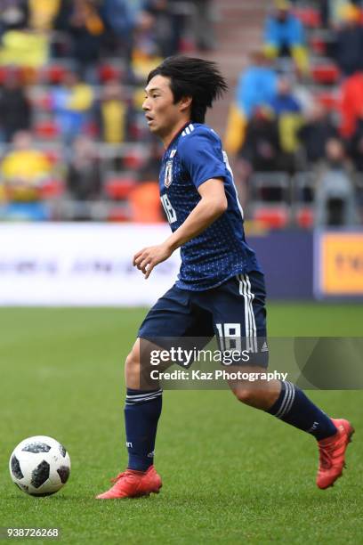 Shoya Nakajima of Japan dribbles the ball during the international Friendly match between Japan and Ukraine at Stade Maurice Dufrasne on March 27,...