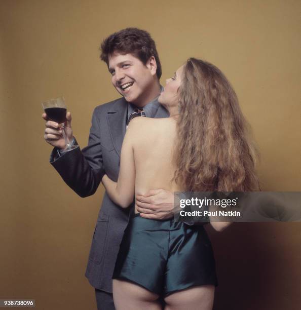 Portrait of singer Wazmo Nariz standing with an unidentified female model in a photo studio in Chicago, Illinois, October 7, 1980.