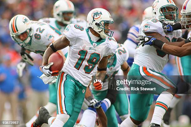 Ted Ginn Jr of the Miami Dolphins carries the ball during the game against the Buffalo Bills at Ralph Wilson Stadium on November 29, 2009 in Orchard...