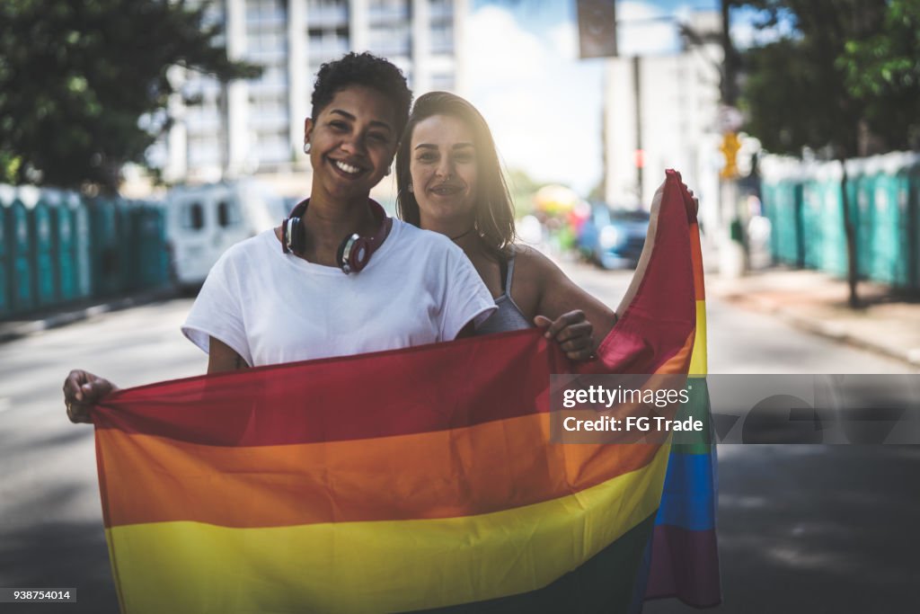 Pareja de lesbianas con la bandera del arco iris