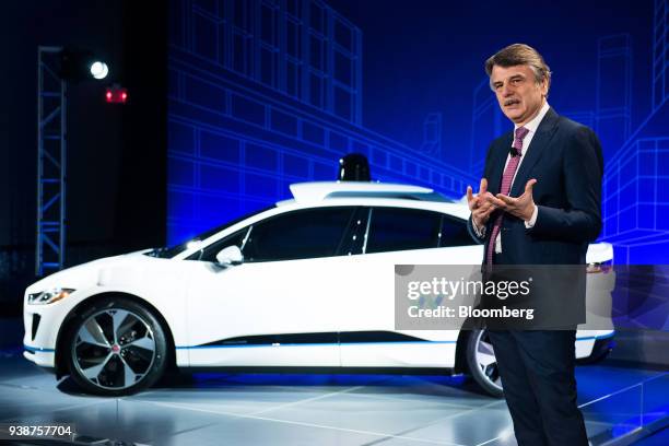 Ralf Speth, chief executive officer of Jaguar Land Rover Plc, speaks while standing in front of the Jaguar I-Pace with Waymo autonomous electric...