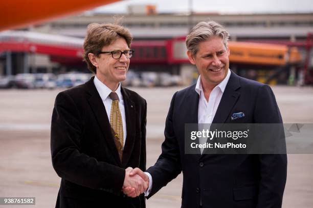 Easyjet-CEO Johan Lundgren and Chief of Berlin-Brandenburg Airport society Engelbert Luetke Daldrup shake hands in front of an easyJet plane carrying...