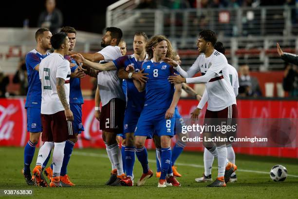 Players from Mexico and Iceland react after an altercation between Birkir Bjarnason of Iceland and Miguel Layun of Mexico during their match at...